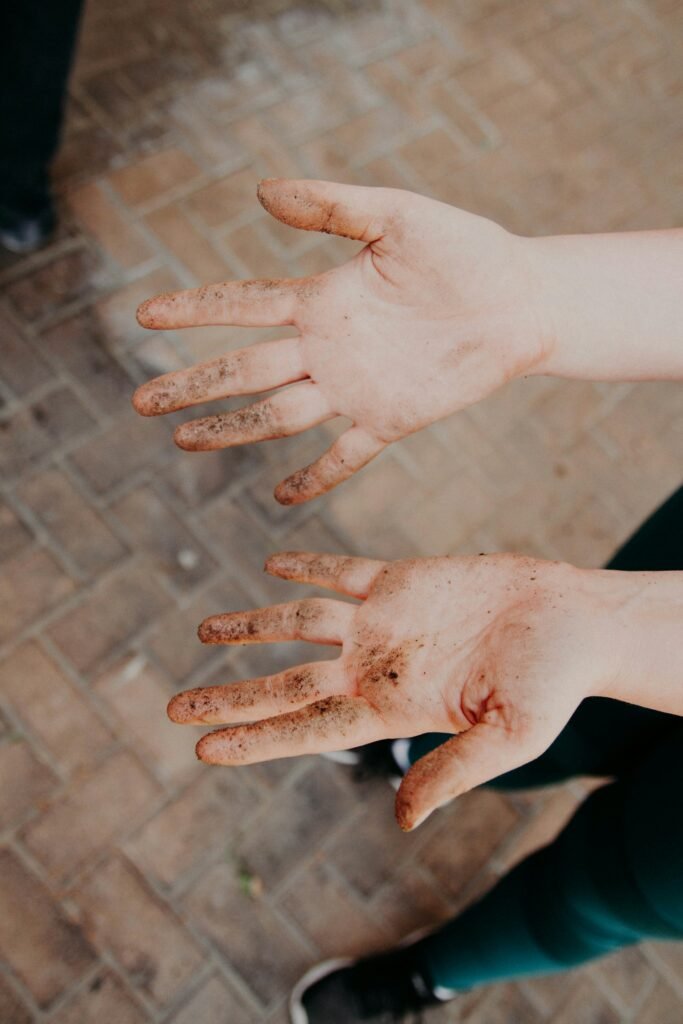 a picture of  hands showing dirt